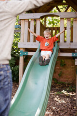 Father catching son on slide