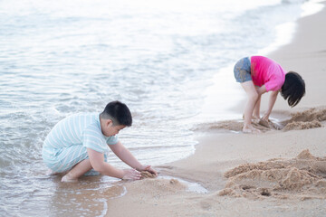 kid playing sand on the beach, Children playing in the sea