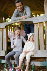 Fototapeta premium Father and children playing on playset