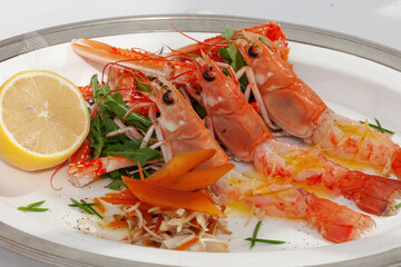 Grilled crudo langoustines with salad and lemon