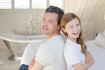 Fototapeta premium Father and daughter smiling in bedroom