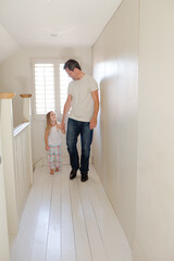 Father and daughter walking in corridor