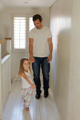 Fototapeta na wymiar Father and daughter walking in corridor