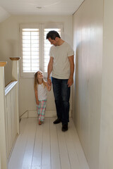 Fototapeta na wymiar Father and daughter walking in corridor