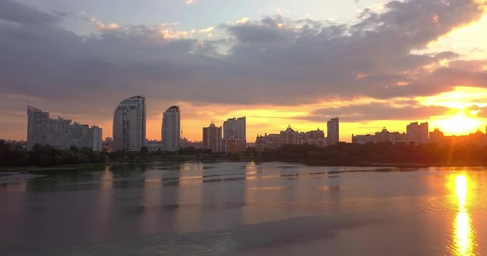 Aerial drone view of Dramatic colorful sunset over Dnipro river and bank of Obolon district in Kiev city, Ukraine