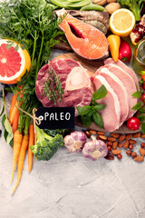 Paleo diet food on light gray background.