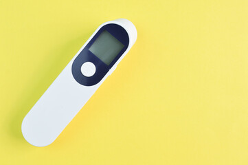 Digital thermometer isolated on a yellow background