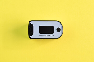 Pulse oximeter isolated on a yellow background