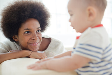 Mother and baby boy sitting on sofa