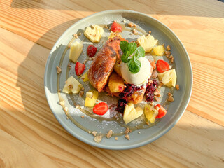 French Toast with ice cream scoop and tropical fruit at timber wooden table, perfect high resolution image for display products