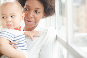 Fototapeta premium Mother holding baby boy