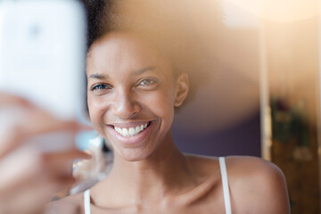 Smiling woman using cell phone