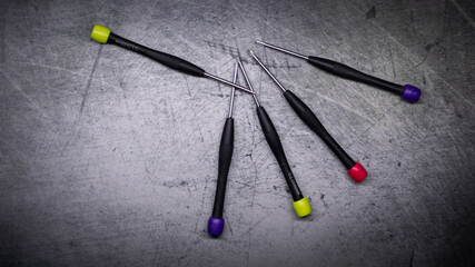 colored screwdrivers on an abstract background