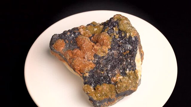 Some shots of a mineral with oxidized baryte on a bed of blende, with black, orange and yellow colors. About 15 centimeters in size. Mineral found in the south of France.
