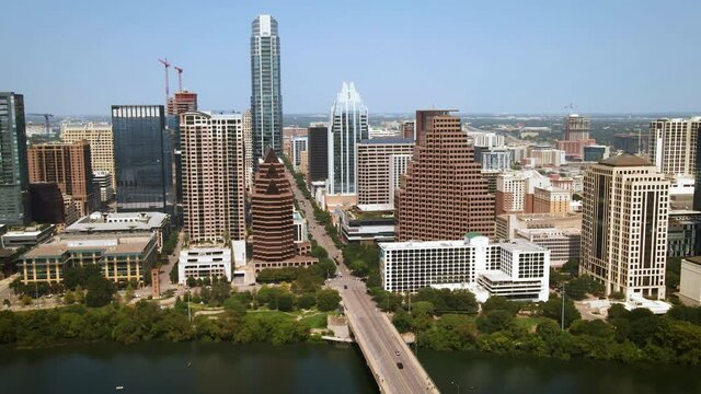 Aerial view of downtown Austin from Lady Bird Lake North toward Texas State Capitol Building, drone 4K