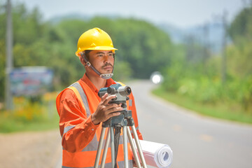 Surveyor engineer worker making measuring with theodolite on road works.survey engineer in...
