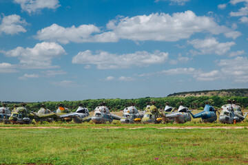 Old abandoned helicopters, broken non-working helicopters, cemetery of old helicopters. 