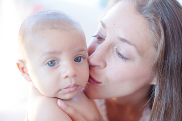 Mother kissing baby boy's cheek