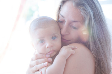 Bare chested mother holding baby boy