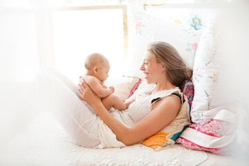 Obraz na płótnie Canvas Mother playing with baby boy