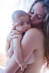 Bare chested mother holding baby boy