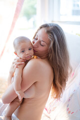 Bare chested mother holding baby boy
