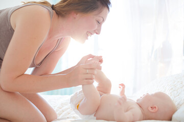 Obraz na płótnie Canvas Mother playing with baby girl