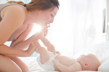 Mother playing with baby girl