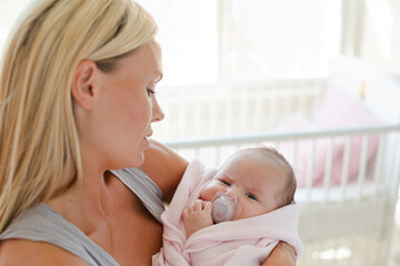 Mother holding baby girl