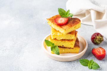 Cottage cheese casserole with strawberries and mint. Delicious homemade dessert made of curd and fresh berries with cream. copy space