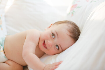 Fototapeta na wymiar Baby boy smiling on bed