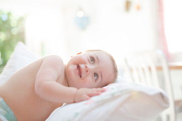 Baby boy smiling on bed
