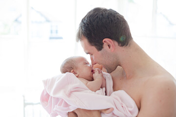 Father holding crying baby girl