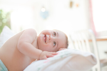 Obraz na płótnie Canvas Baby boy smiling on bed