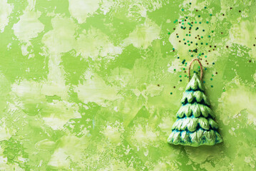 New year holidays background 2022. Christmas tree with sparkles on green background with copy space
