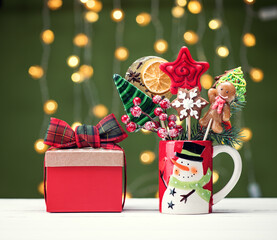 concept background new year 2022. Christmas gingerbread and candy on sticks and gift boxes. Merry christmas festive background with sweets and decorations