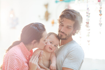 Obraz premium Parents smiling with baby boy