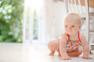 Baby girl crawling on floor