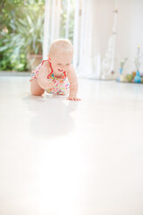 Baby girl crawling on floor