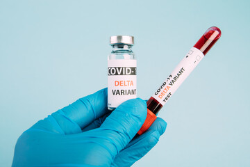 covid 19 delta Variant vaccine and test blood in hand on blue background. vaccination against...