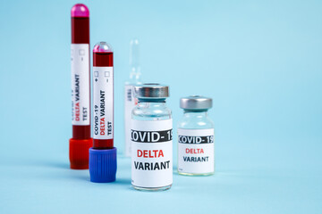 covid 19 delta Variant vaccine and test blood in hand on blue background. vaccination against coronavirus
