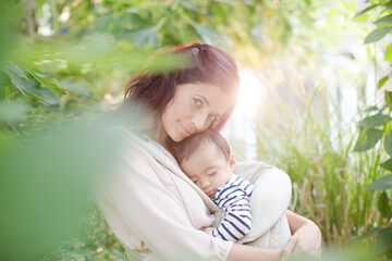 Mother holding baby boy outdoors