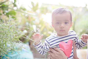 Mother holding baby girl outdoors