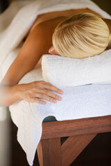 Woman laying on massage table in spa