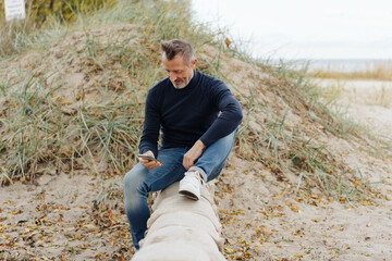 Athletic senior man relaxing in the sand dunes on a beach