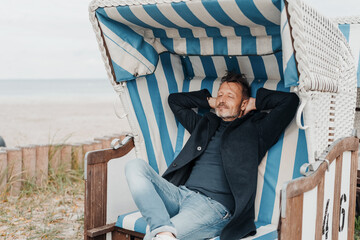 Man chilling in a beach chair at a coastal resort