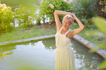 Fototapeta premium Woman stretching by pool outdoors