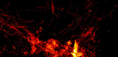 Fototapeta na wymiar Sparks from fire on a black