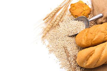 Delicious organic bread with wheat ears and wheat grains There is space to copy text. On a white table top in a rustic kitchen - top view