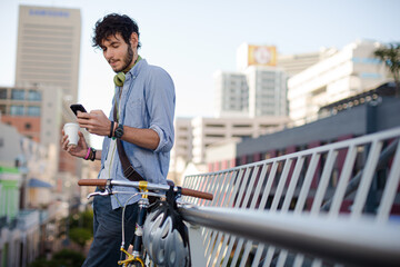 Man using cell phone on city street